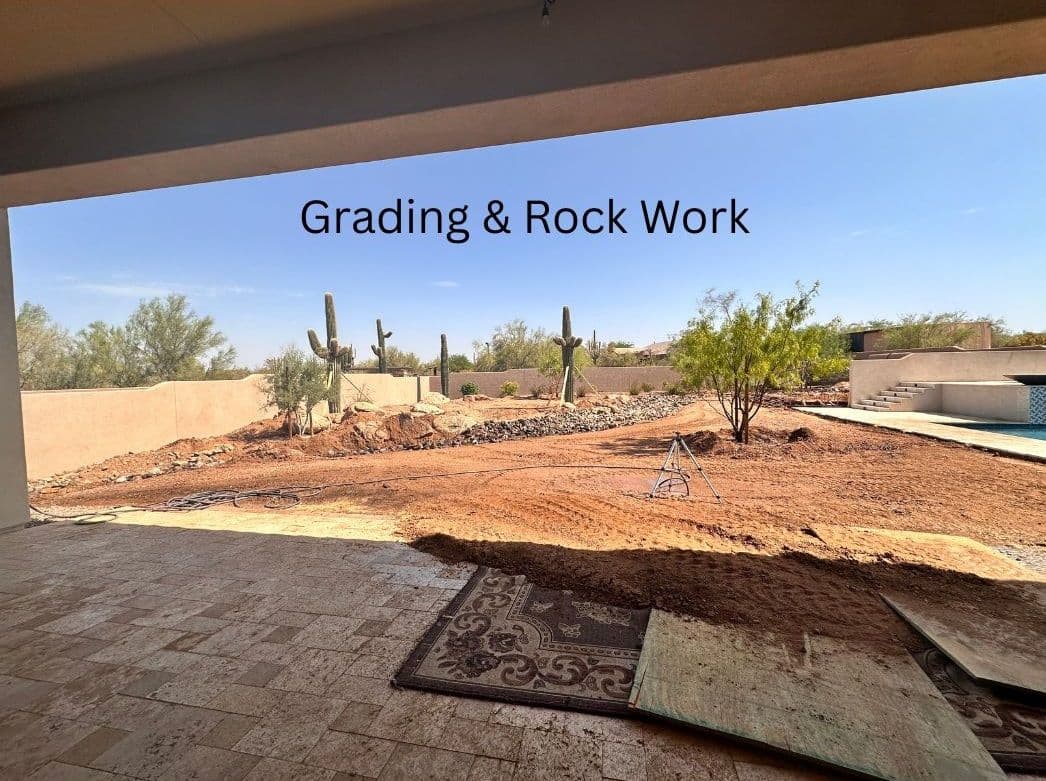 View of a construction site showing grading and rock work with cacti and landscaping.